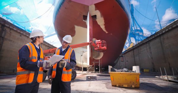 Two man in a ship yard