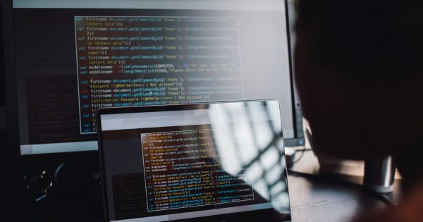 Two computer screens showing code