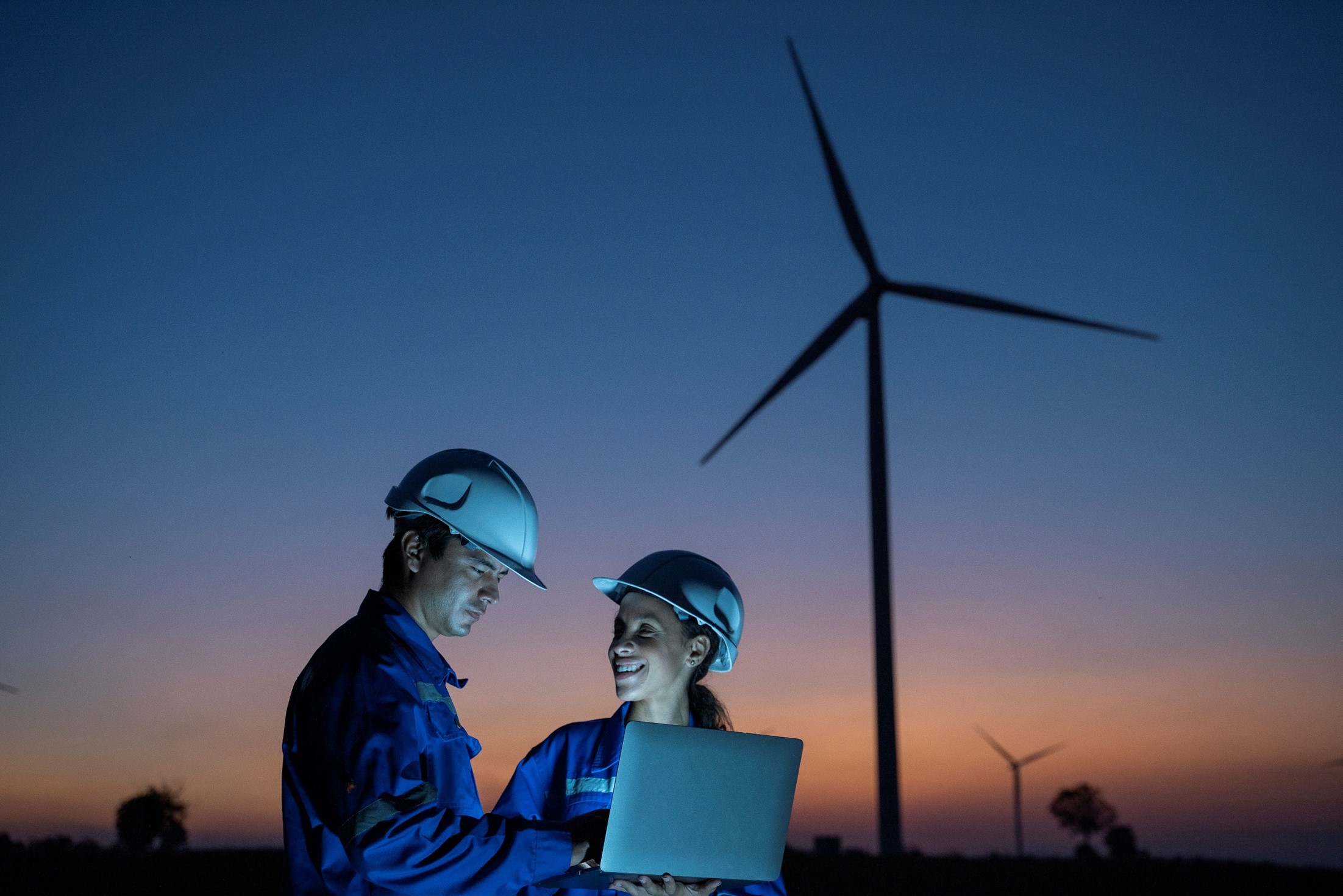 Two engineers looking how to improve sustainability of wind turbines