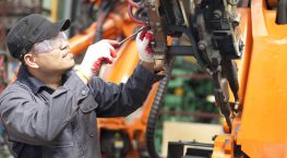 Mechanic repairing a robot machine