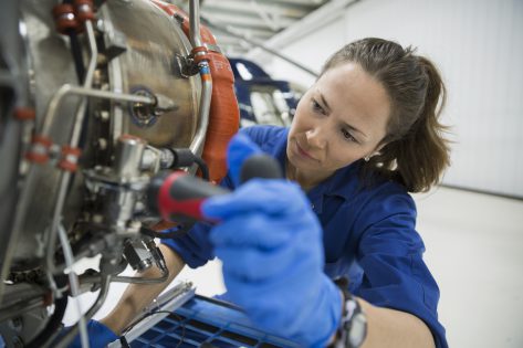 Woman working on remanufacturing an engine
