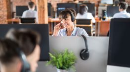 Woman in office in a call about Rethinking ITSM