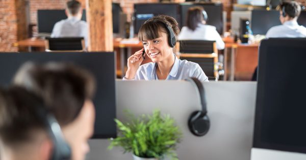 Woman in office in a call about Rethinking ITSM