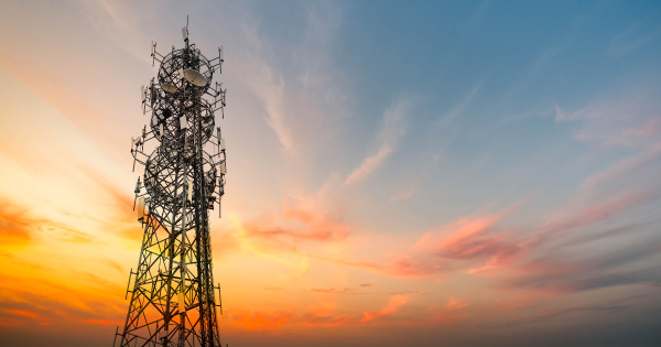 Telecommunications tower at sunset, representing the telecom industry.