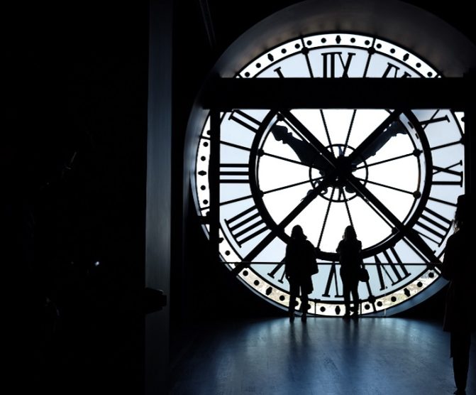 People by a huge clock talking about SAP ECC6