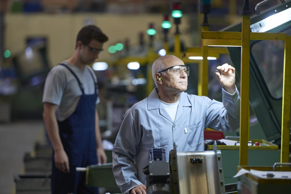Worker at a remanufacturing facility checking the quality of the product.